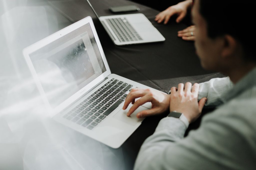 CodeSpace man coding on laptop in an office